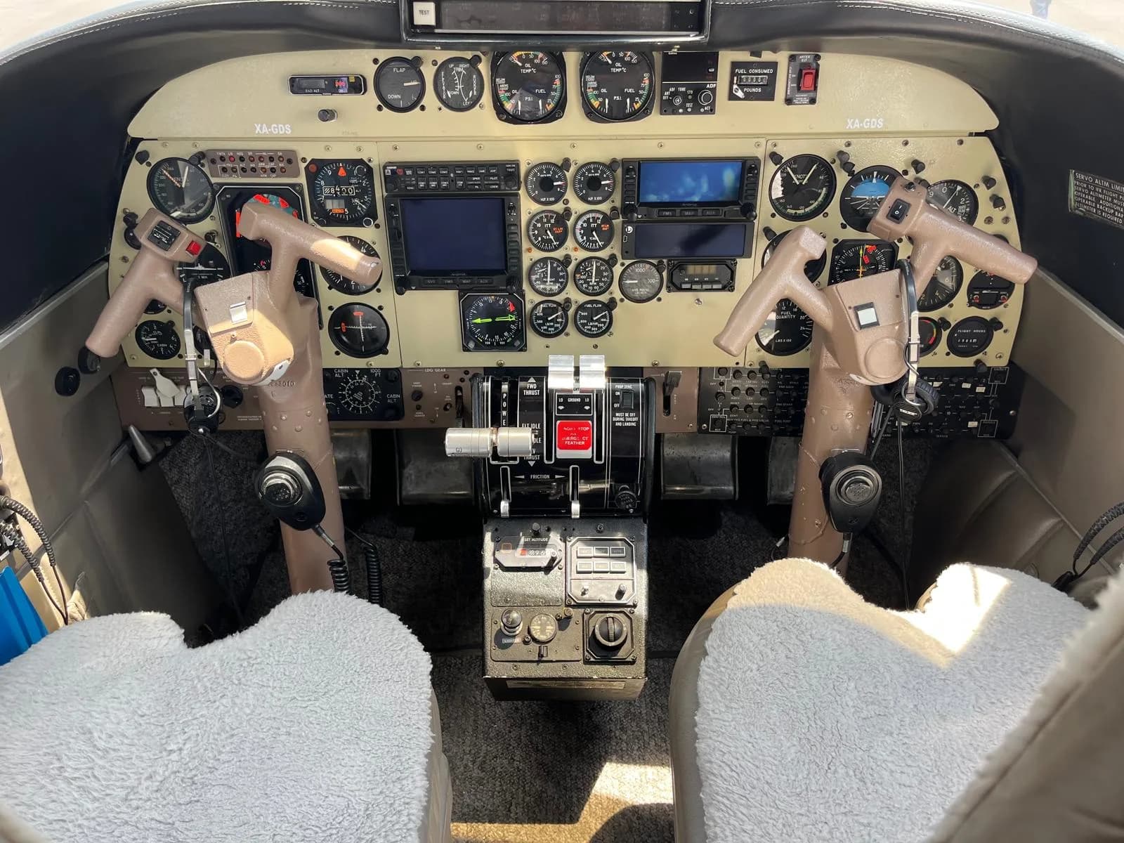 View of the aircraft's cockpit, showing the instrument panel and control sticks.