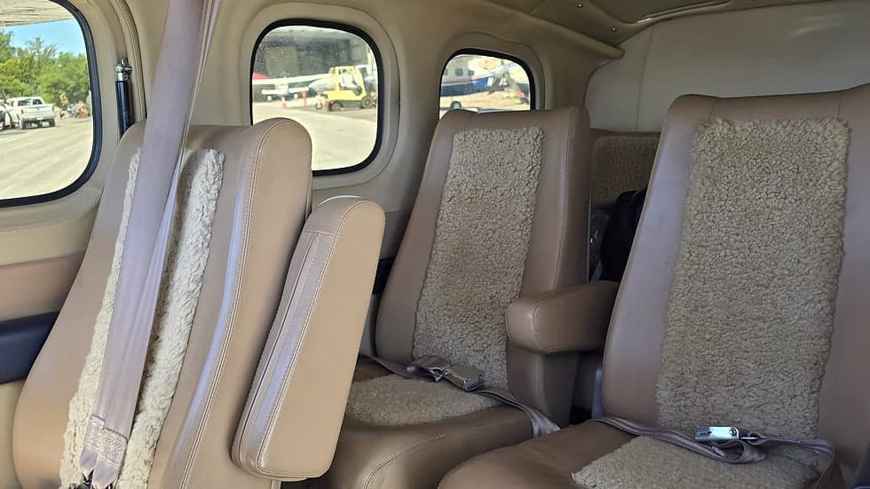 Interior view of the Cessna 207A Turbo Stationair 800 cabin, showing the seats and a view out the window.