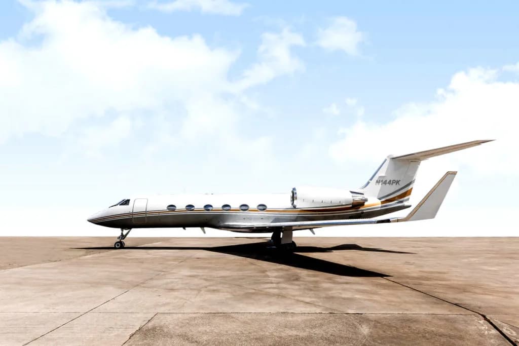 Gulfstream jet with gold accents parked on the tarmac.