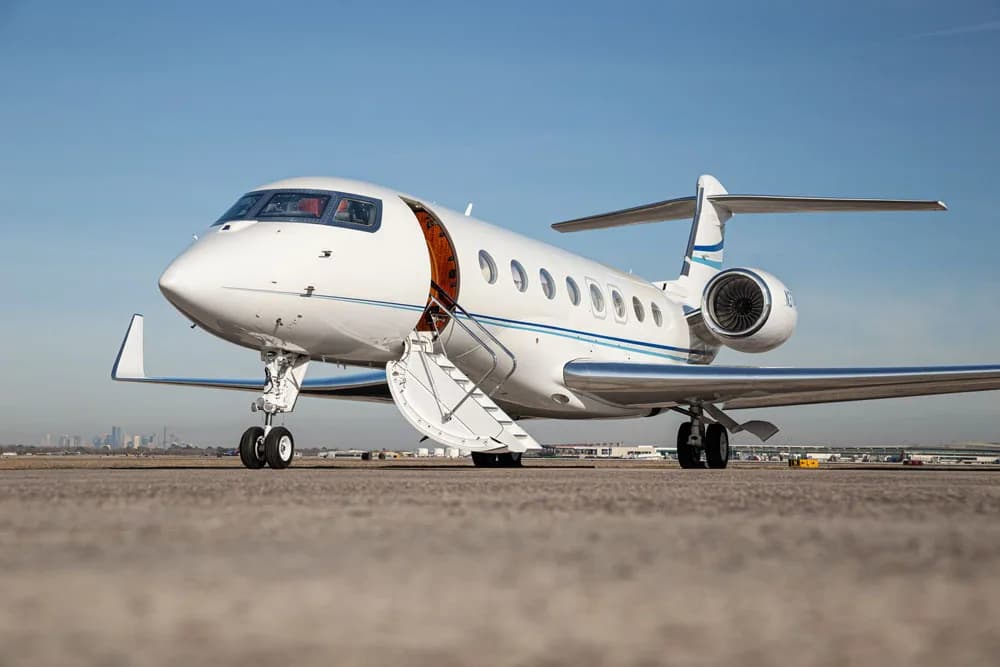Gulfstream jet on the tarmac with the door open.