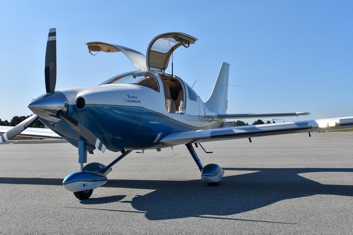 Front view of a Bluebird Columbia 350 aircraft with a blue and white paint scheme.