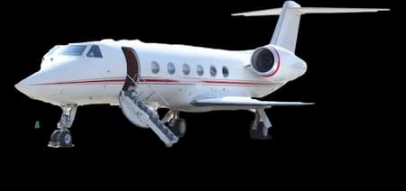 A white business jet with a red stripe, parked on the ground with its airstairs deployed.