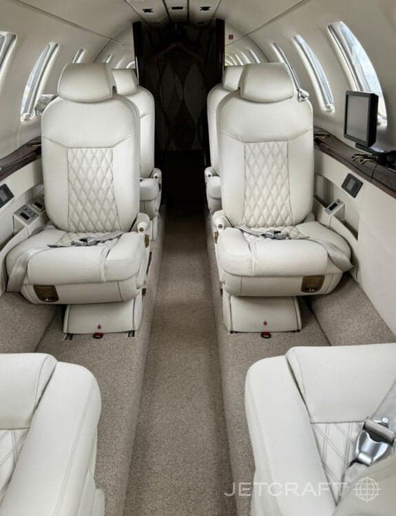 View of the interior cabin with white leather seats.