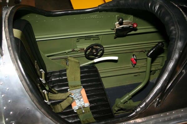 View of the cockpit showing the seat, harness, and controls.