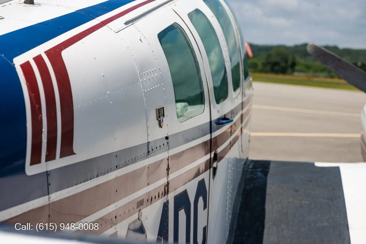Close up of the side of a Beechcraft Baron showing the door and windows.