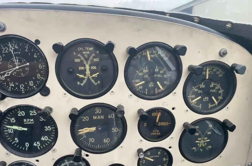 A detailed close-up of a section of the aircraft's instrument panel, displaying engine and system gauges.