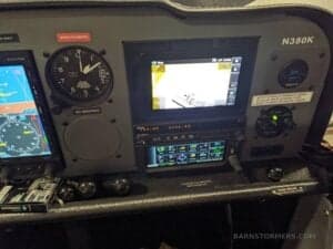 Close-up of the aircraft's instrument panel featuring multiple displays and gauges, including the tail number N380K.