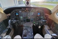 Rear quarter view of a Cessna Citation CJ3+ with red and black stripes.