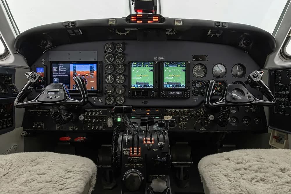 The cockpit of the King Air aircraft features a full instrument panel and controls.