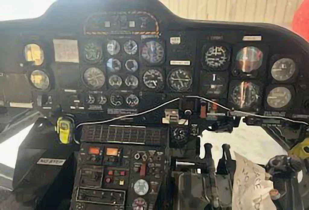 The instrument panel of a helicopter, filled with various gauges and controls.