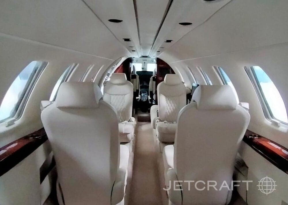 View of the interior cabin with white leather seats.