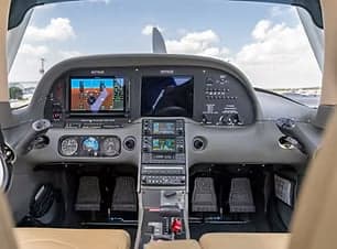 The instrument panel of a Cirrus SR22 aircraft with dual screens.