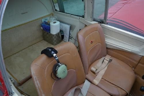 Interior view of the aircraft cabin showing the seats and storage.