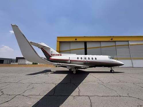 A Hawker 400XP aircraft with tail number N855MW parked on the tarmac.