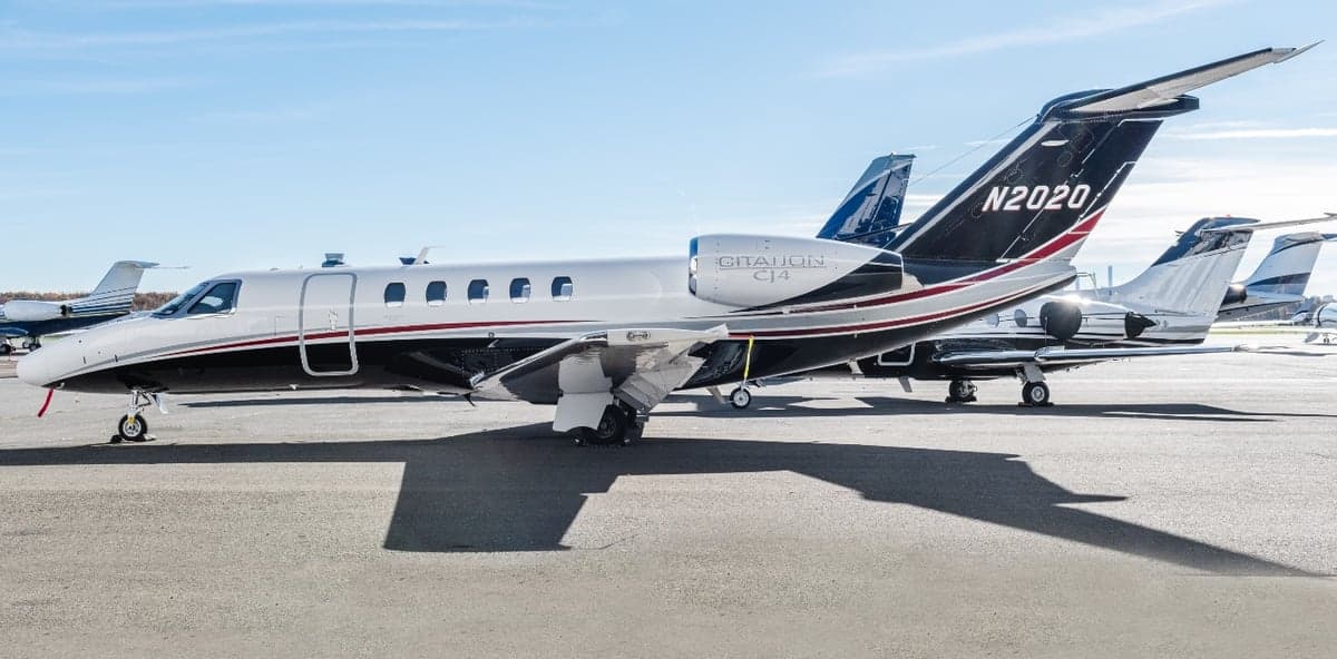 A Citation CJ4 aircraft with registration N2020 parked on the tarmac.