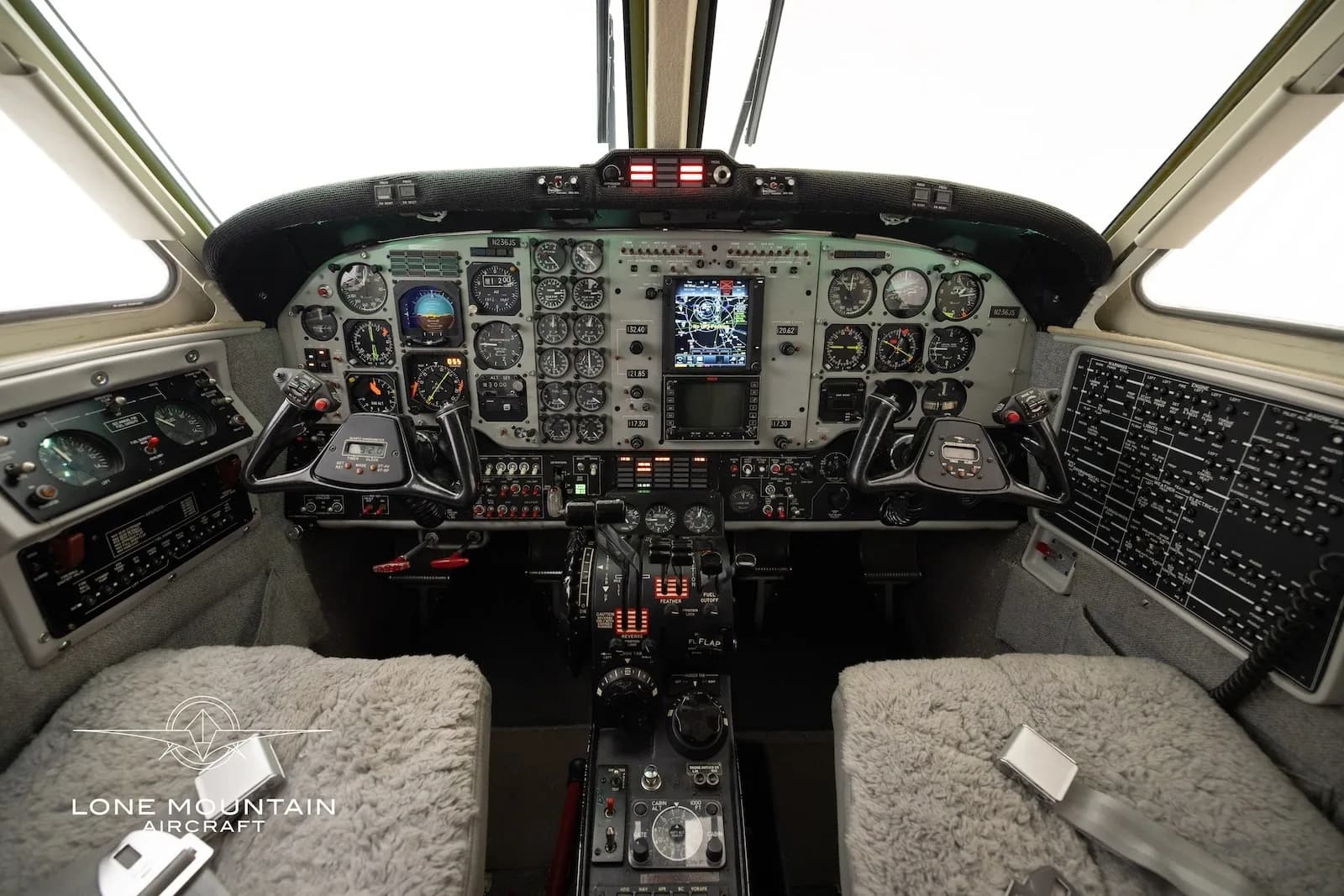 The aircraft's cockpit features a complex instrument panel with multiple gauges and a central display.