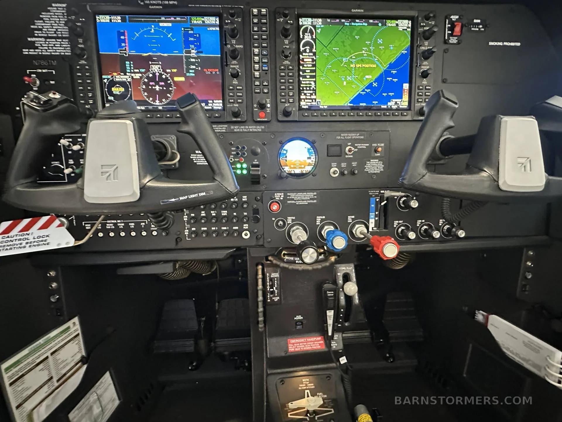 The cockpit of a Cessna T206 features a modern glass panel with multiple Garmin displays and dual yokes.