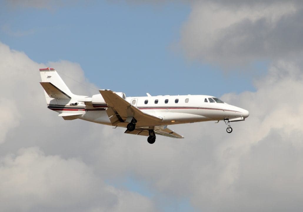 A Citation Latitude aircraft in flight with landing gear down.