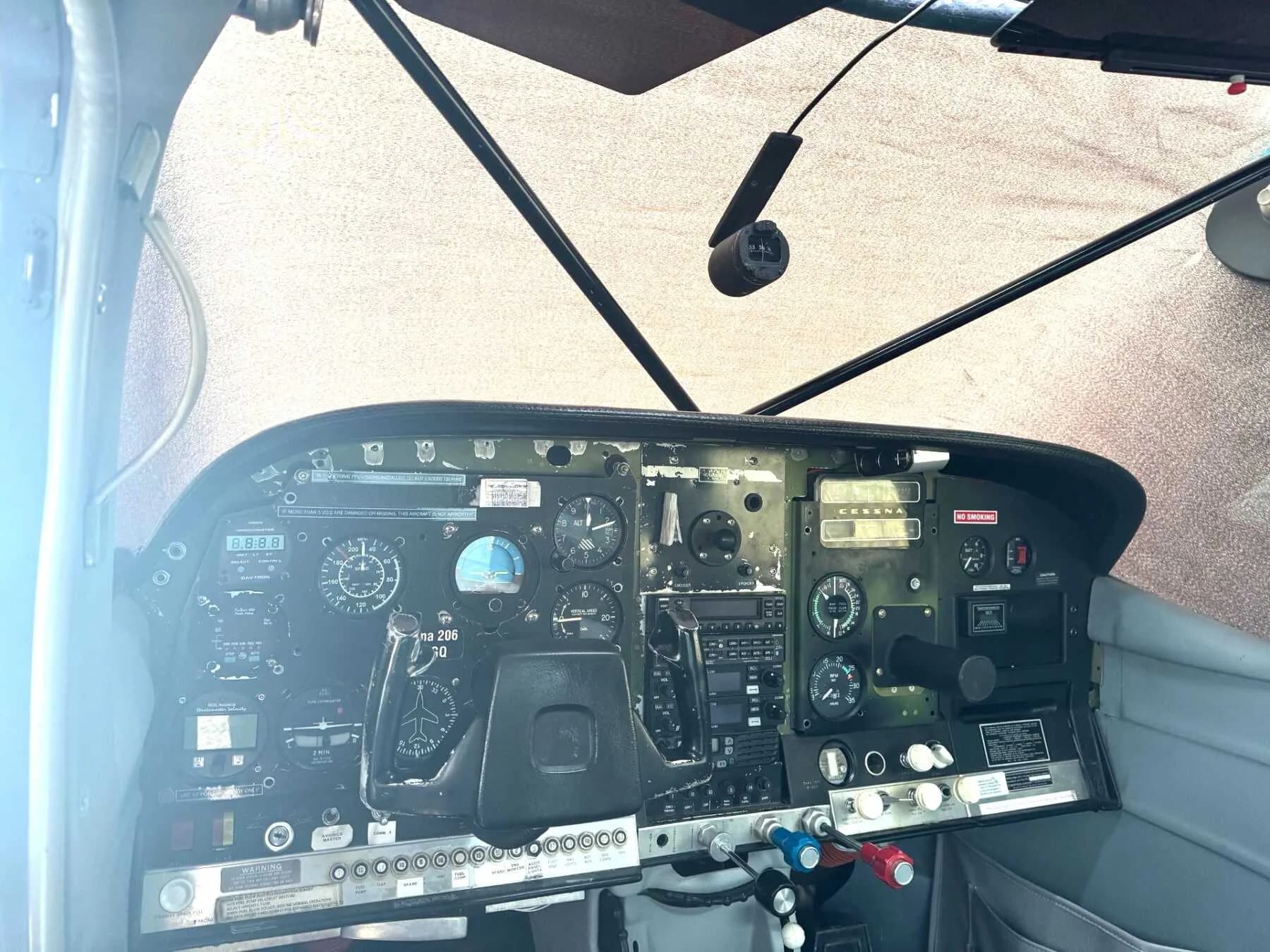 The cockpit of a Cessna 206 Stationair with a detailed instrument panel.