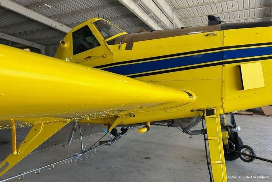 Close up of a yellow and blue Air Tractor aircraft.