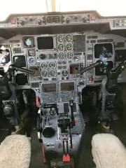 The cockpit of an aircraft with many instruments and controls.