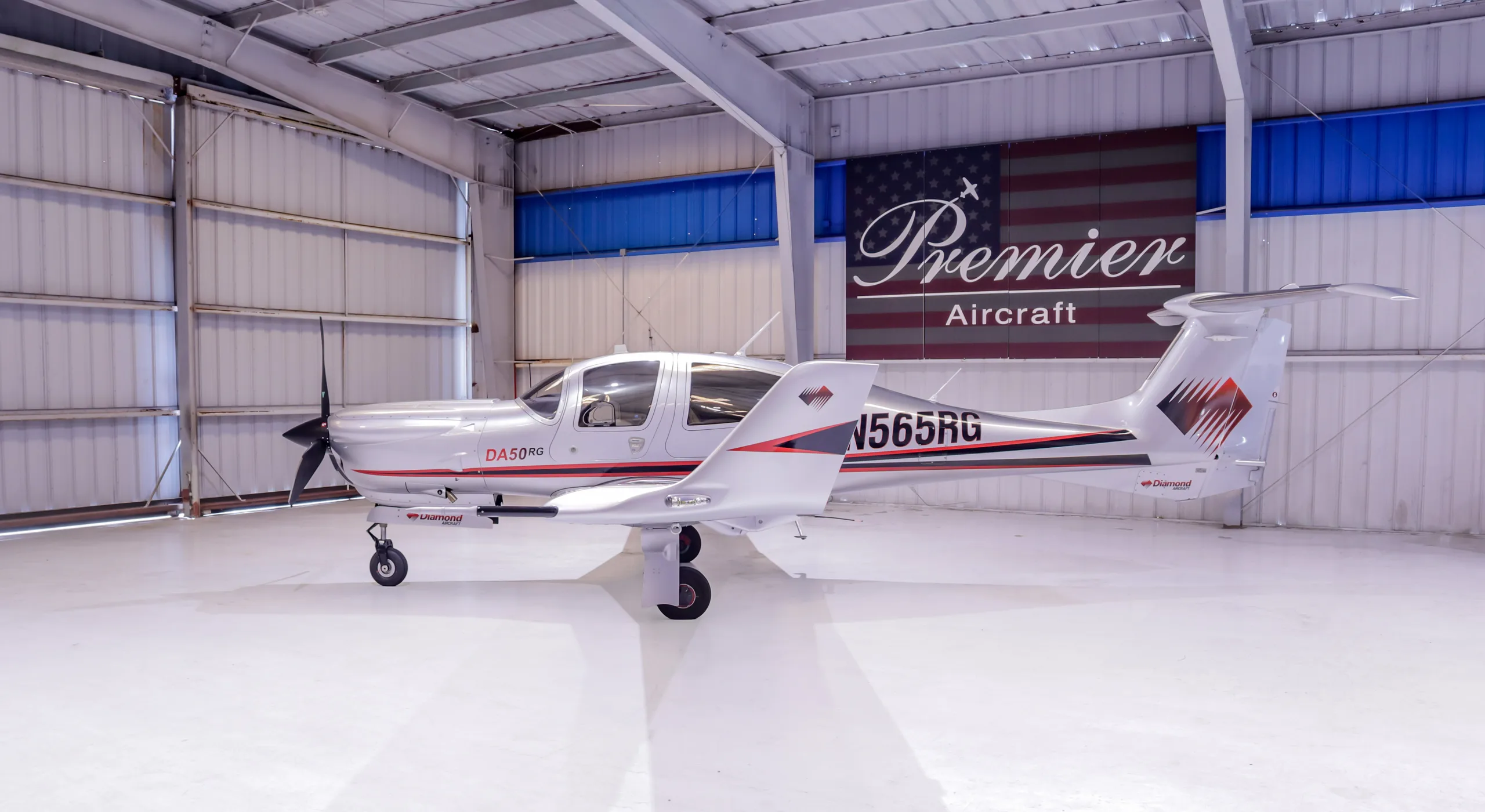 Diamond DA50RG aircraft N565RG parked in a hangar.