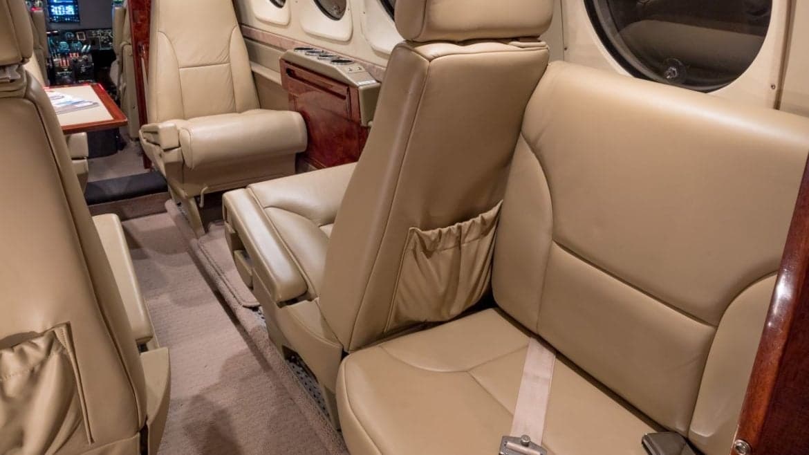 Interior view of the aircraft cabin showing the seating arrangement and cockpit.
