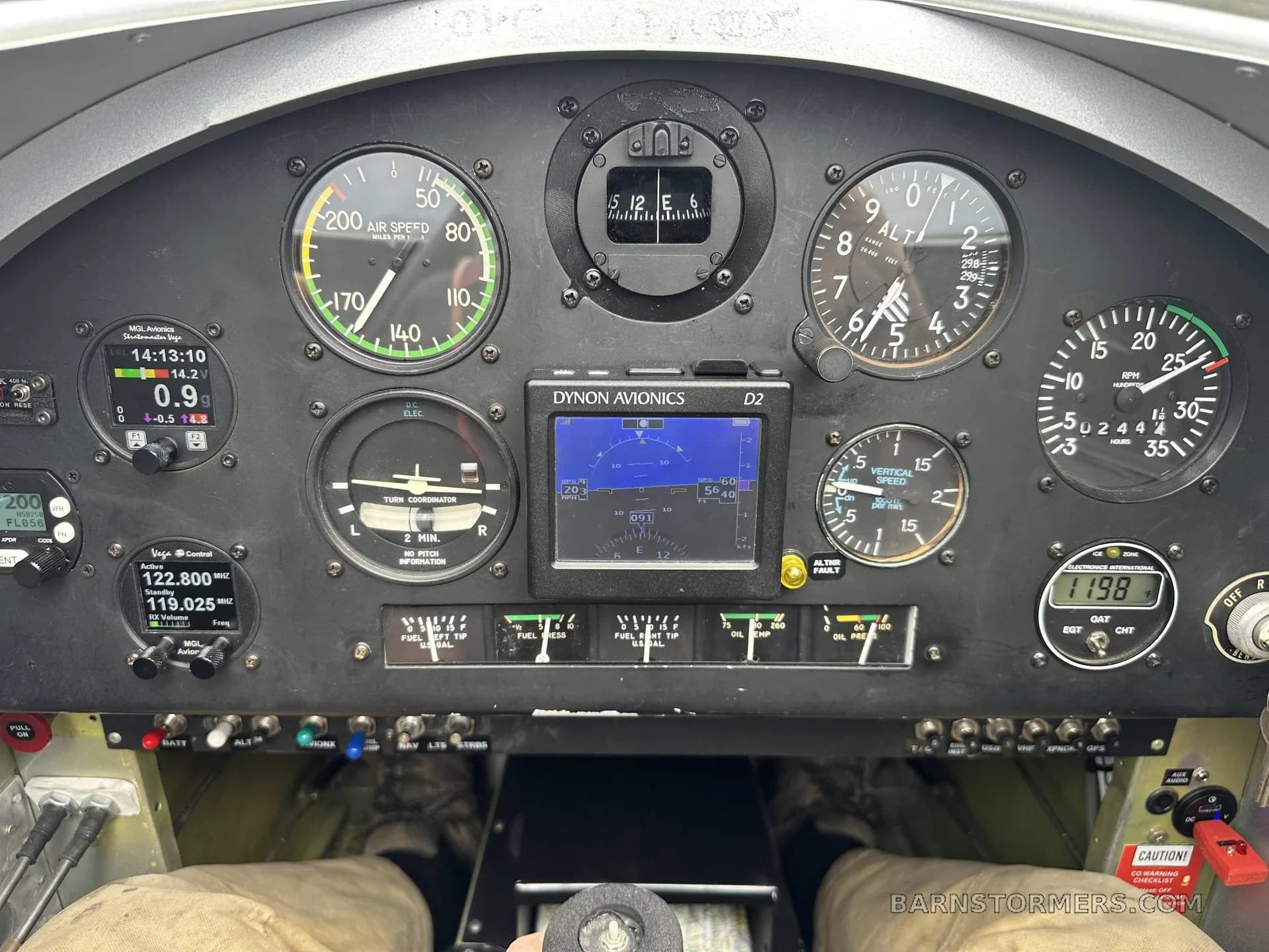 A close-up view of the aircraft's instrument panel, featuring analog gauges and a Dynon Avionics D2 digital display.