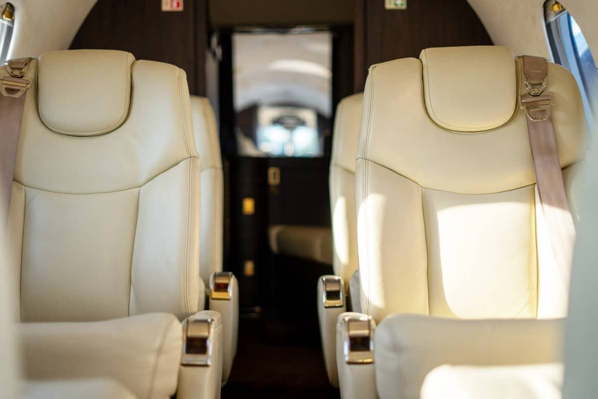 Close-up of the cream leather seats inside the Beechcraft Beechjet 400A cabin.