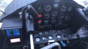 Detailed view of the instrument panel and controls in the cockpit of an aircraft.