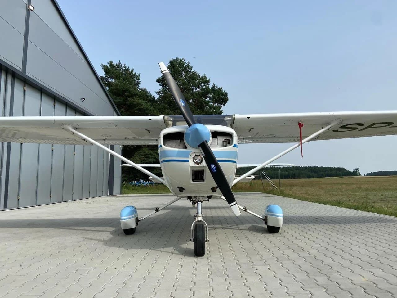 Front view of a Cessna 150 with blue and white paint scheme.