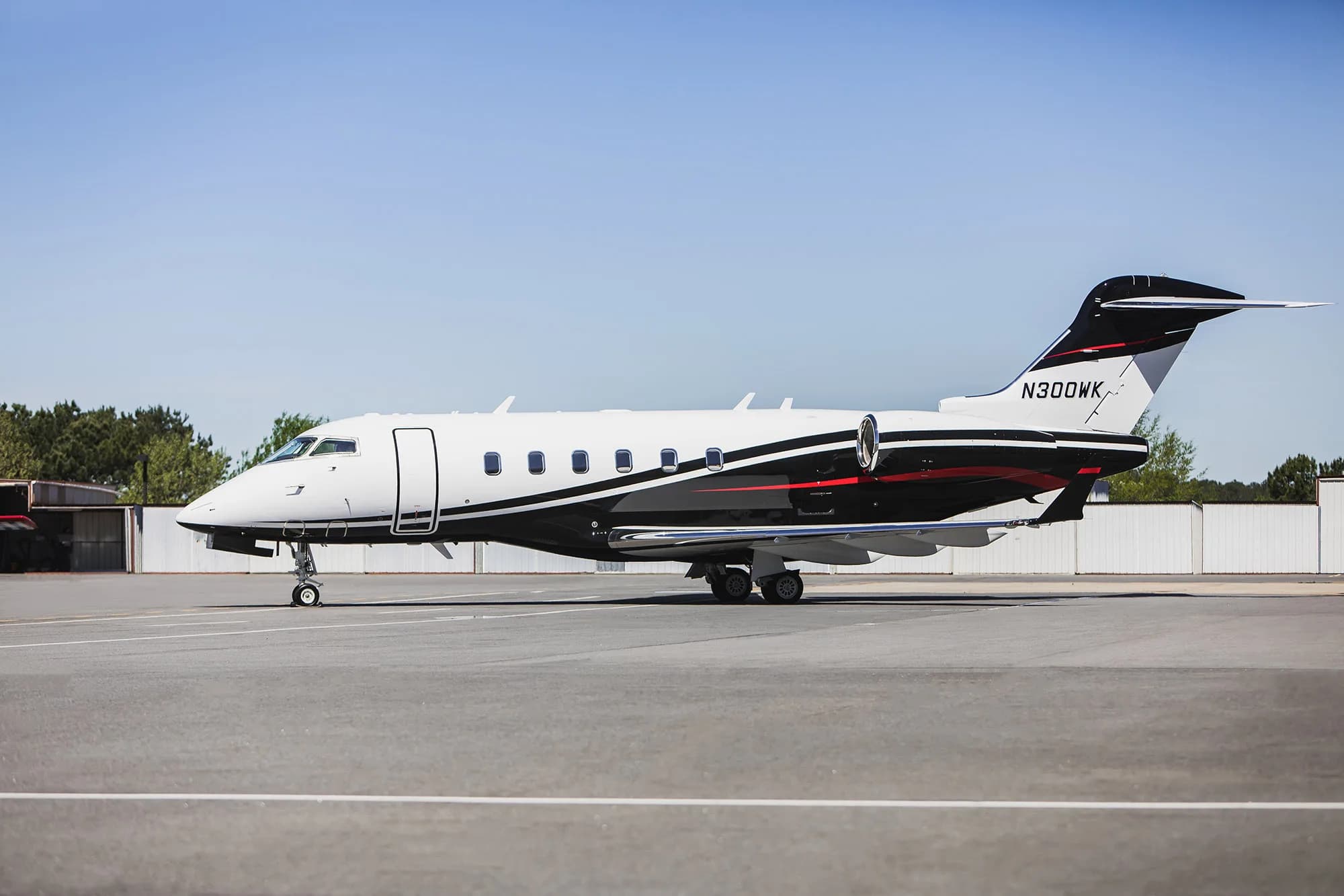 Side view of the N300WK aircraft on the tarmac.