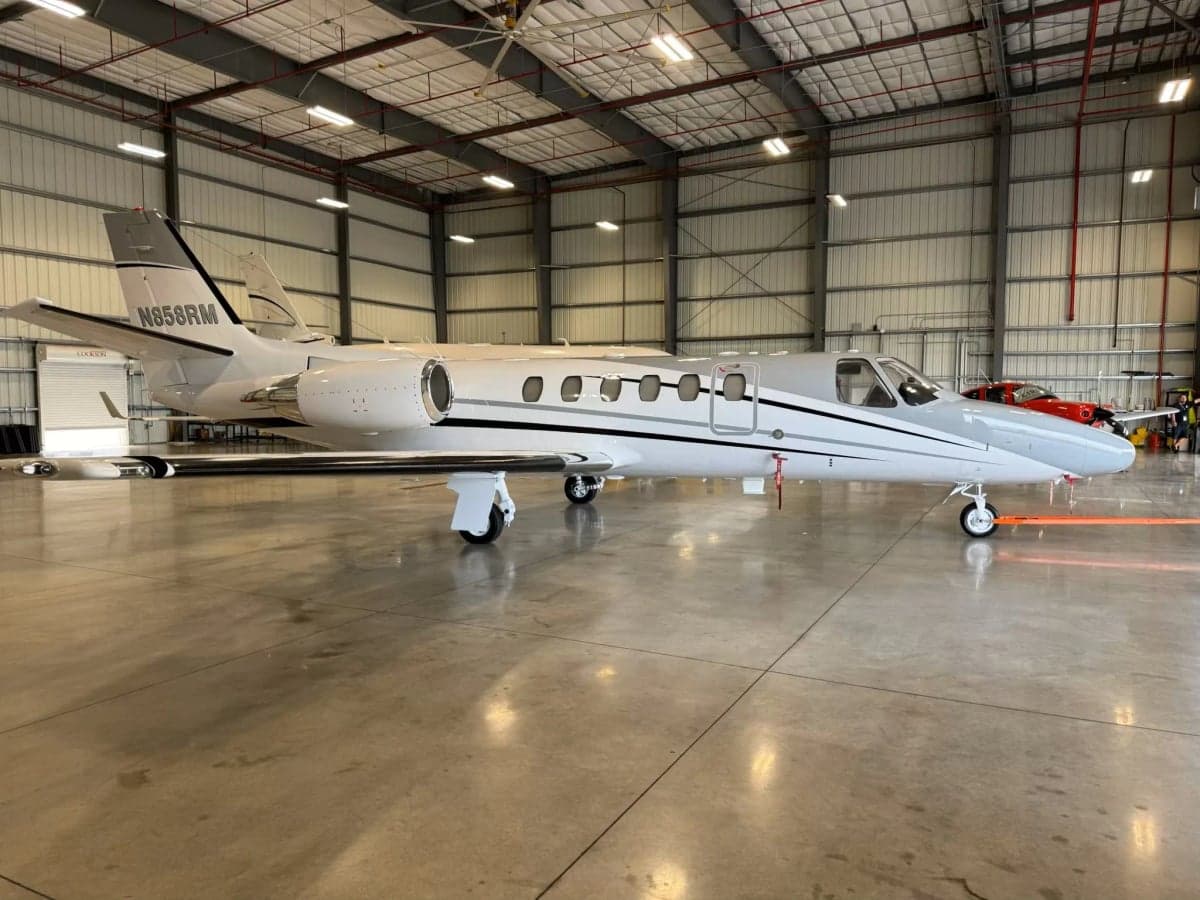 Side view of a Cessna Citation CJ3, registration N858RM, inside a hangar.