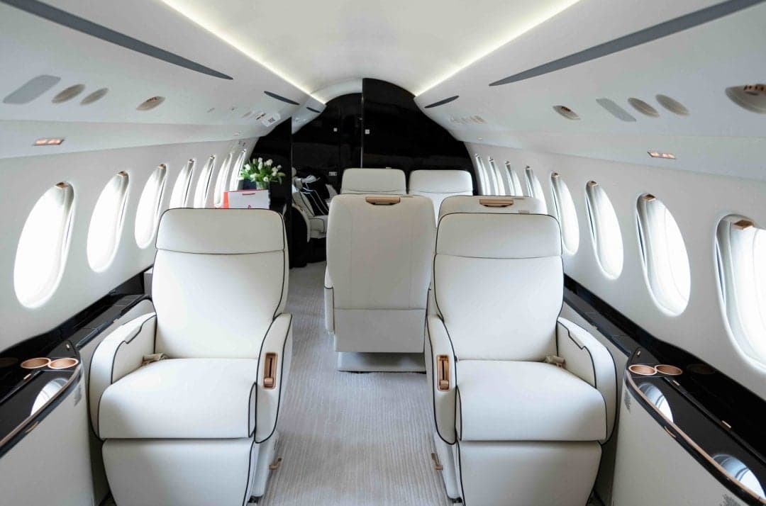 A view of the aircraft's interior with white leather seats.