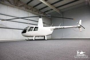 Robinson R44 helicopter N813FA in a hangar.
