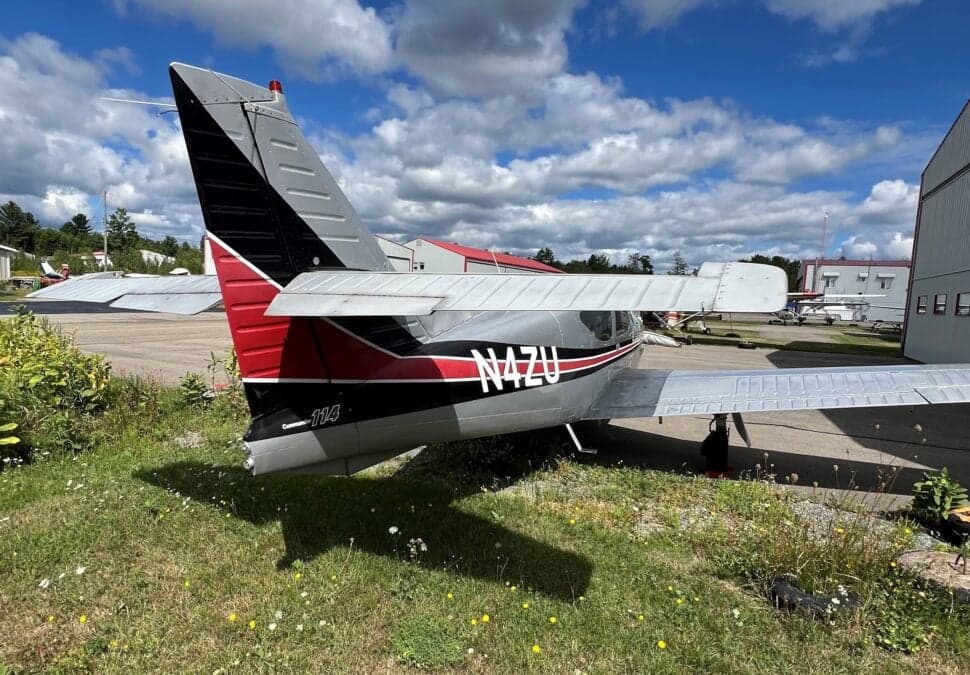 Rear quarter view of the N4ZU Mooney aircraft on the ground.