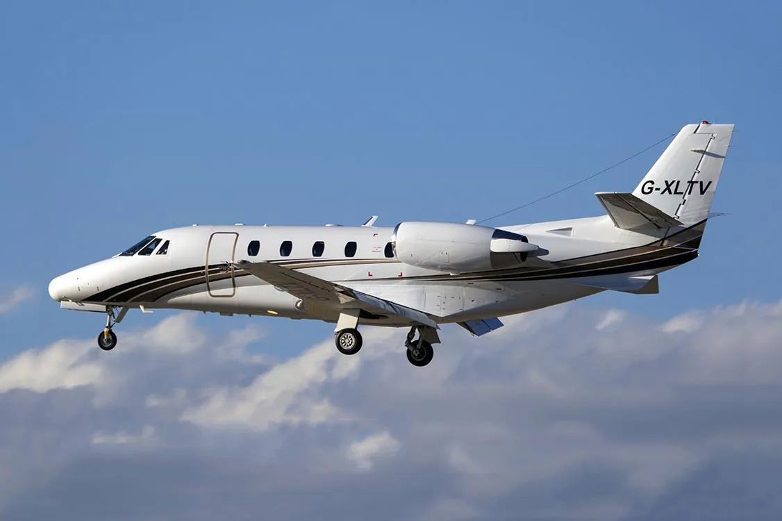 G-XLTV aircraft in flight against a blue sky.