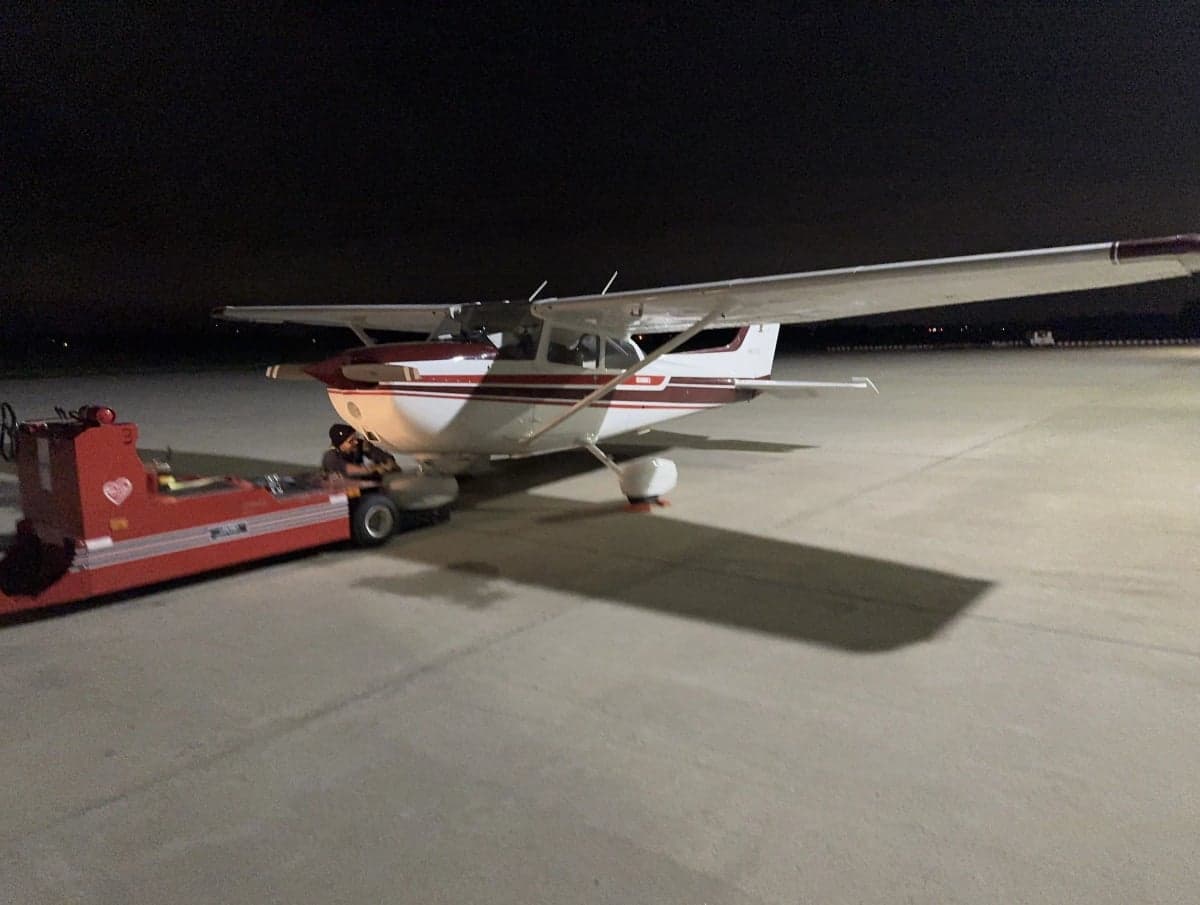 Cessna 172 N4855G being towed at night.