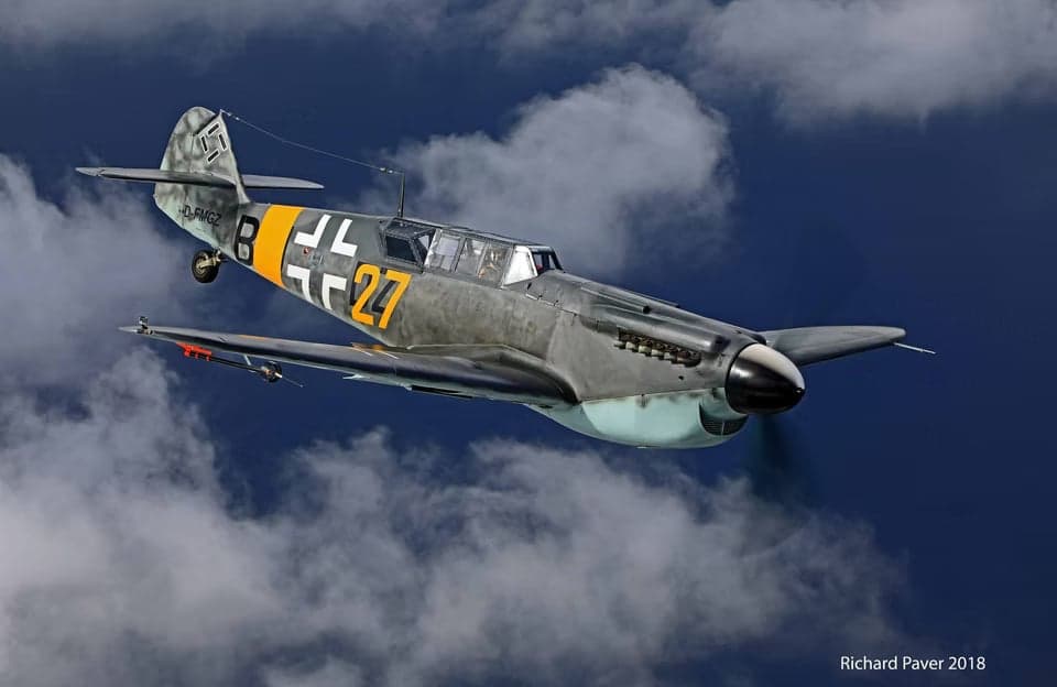 Messerschmitt Bf 109 flying in cloudy skies.