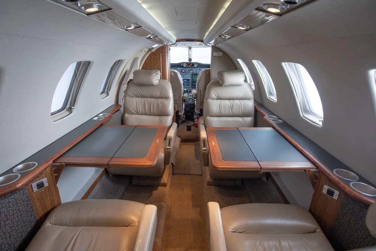 Detailed view of a modern private jet cockpit with multiple digital displays and controls.