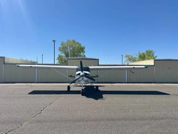 Front view of a white and green Maule aircraft, registration N20RD, parked on a tarmac.