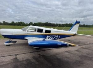 Side view of the N5579J aircraft on the tarmac.