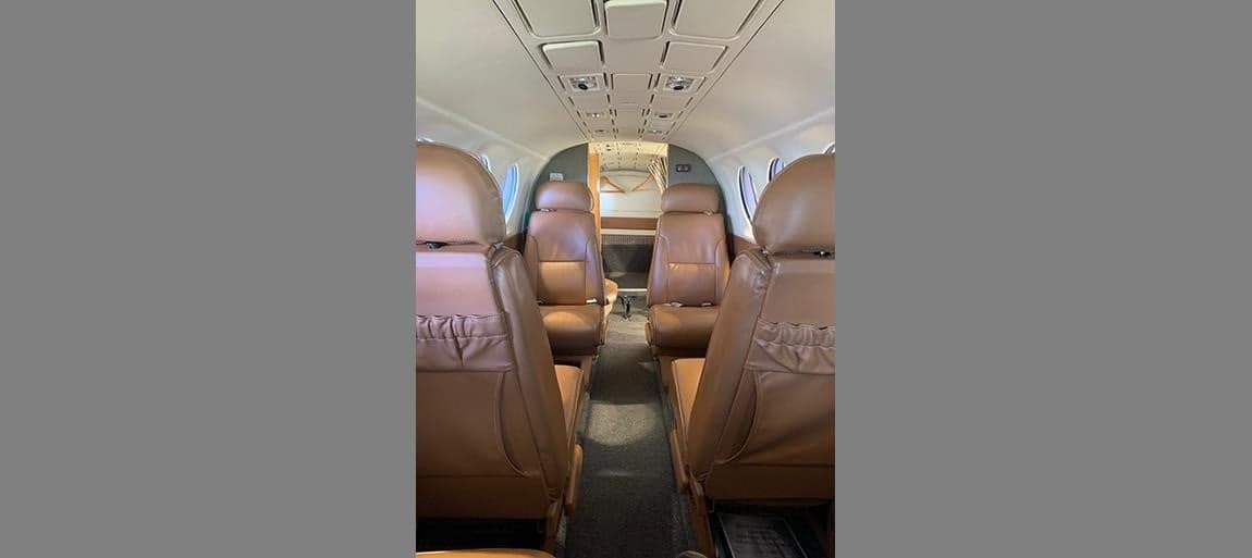 Rear cabin view of the King Air with tan leather seats.