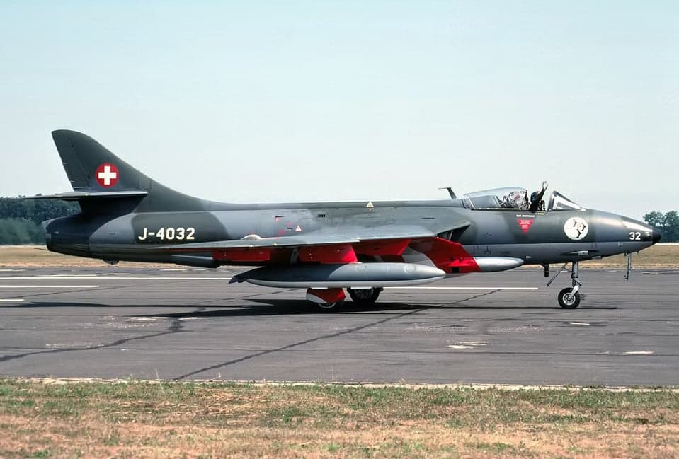 Hawker Hunter J-4032 taking off from a runway.