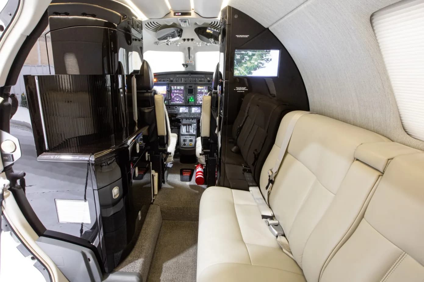 A view of the aircraft's interior, showing the seating arrangement and cockpit.