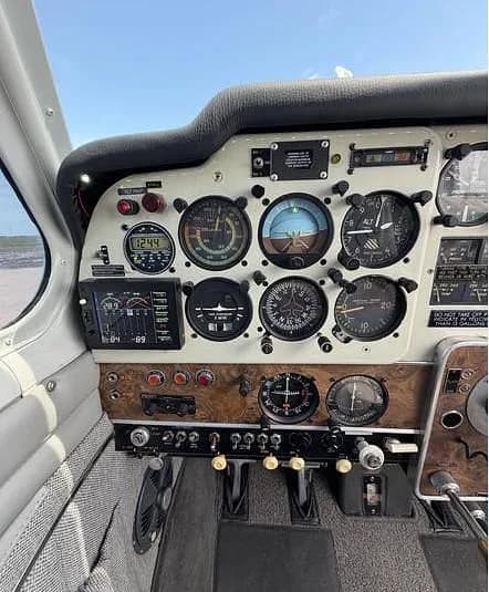 A detailed view of the aircraft's instrument panel with various gauges and avionics.