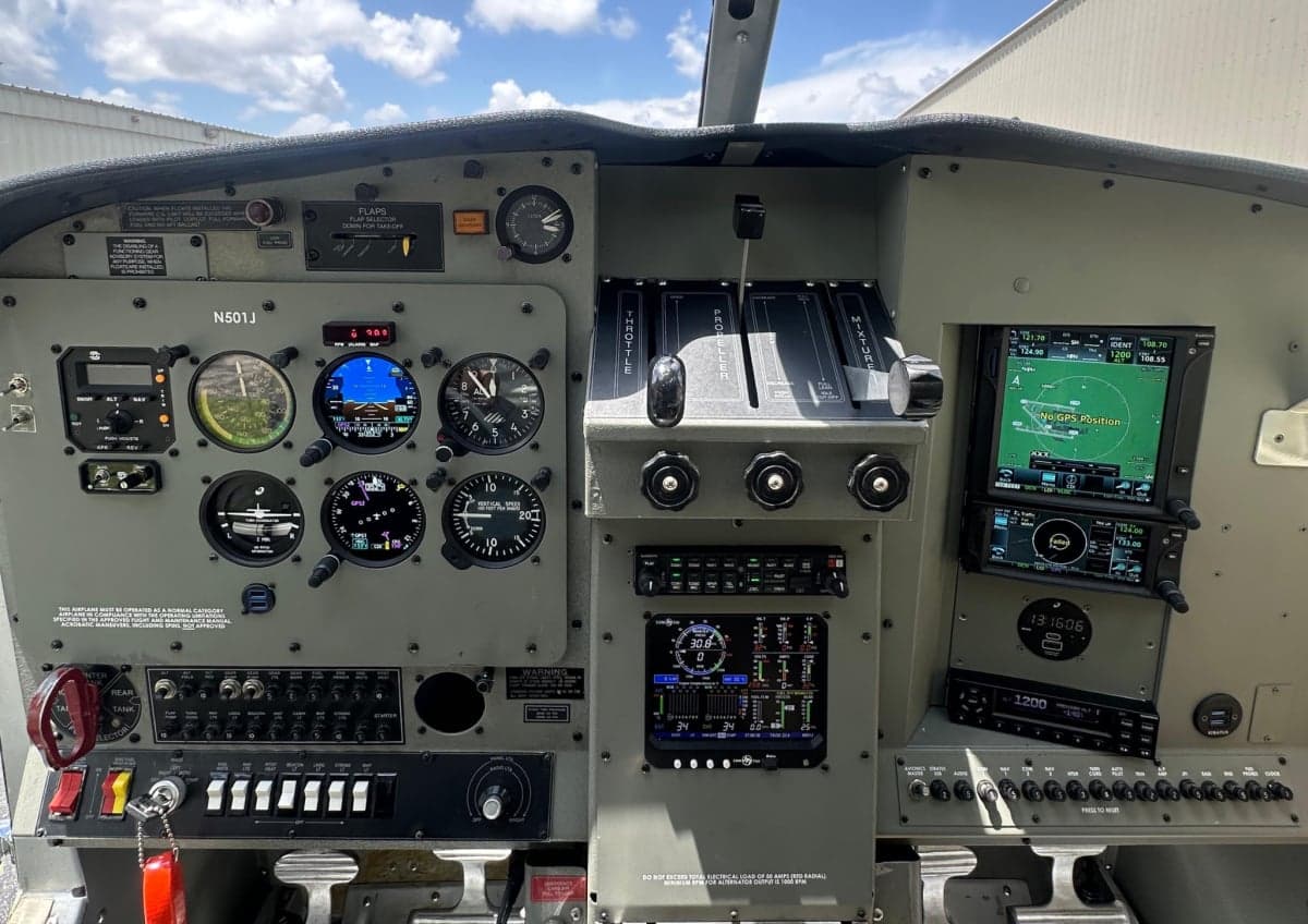 The cockpit of the aircraft features a gray instrument panel with various gauges and displays.