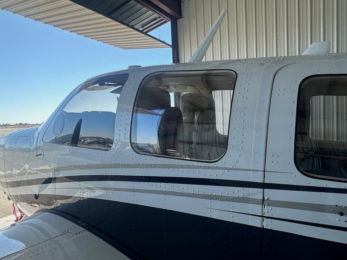 Close-up of the side windows of a Piper PA-31-350 Navajo Chieftain, showing the cabin interior.