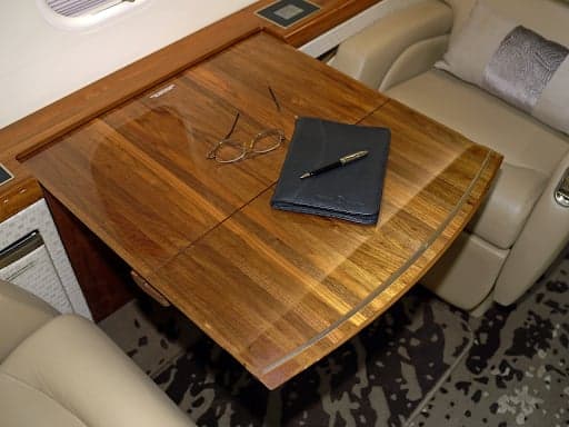 Close up of the Challenger 300 cabin side panel with cup holders and a screen.
