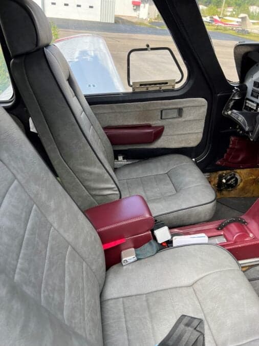 View of the front seats inside the aircraft cabin.